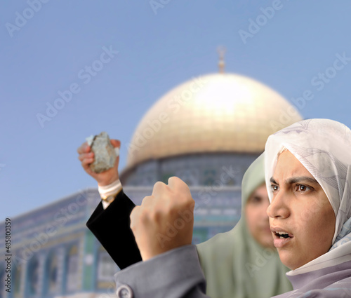 Angry Palestine women fighting with rocks in hands photo