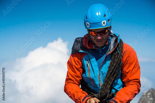 Man with sun glasses is climbing in the mountains. © Zhanna