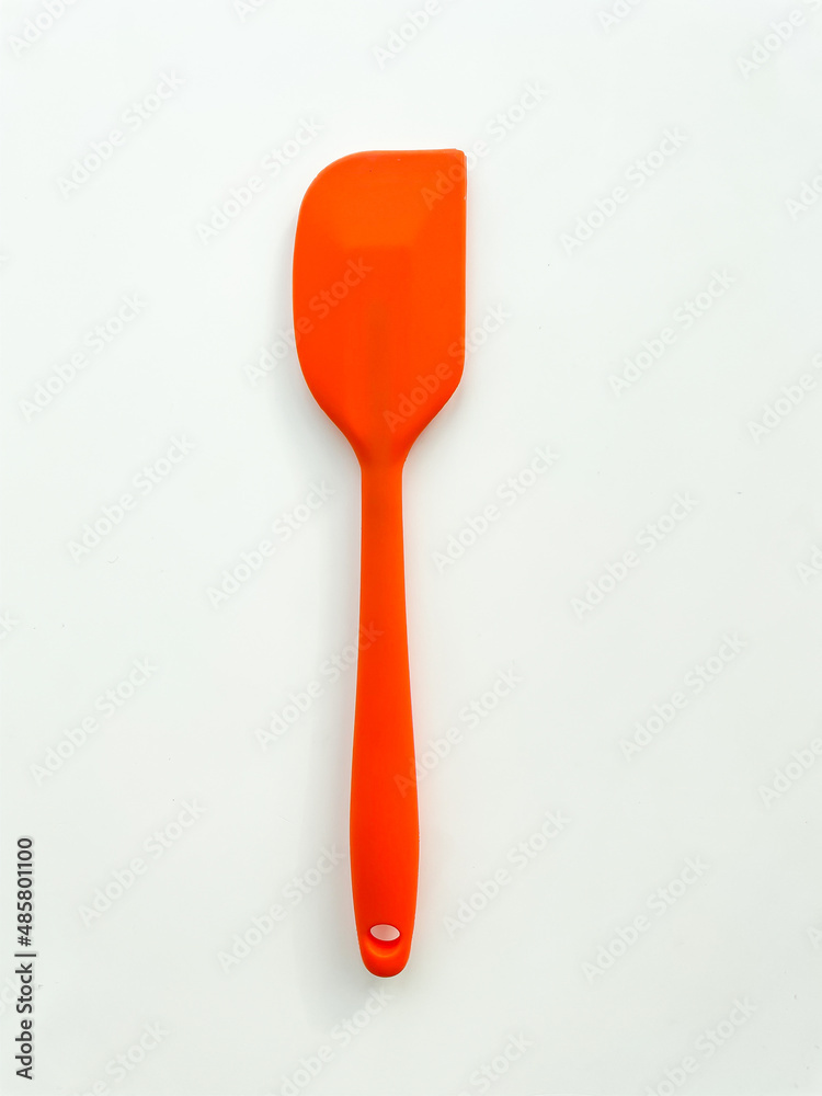 Kitchen spade of frying pan or spatula in orange color on white isolated background. Kitchenware. Cookware and utensils concept for cooking food.