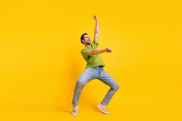 Full size profile side photo of young man have fun ride horse look empty space isolated over yellow color background
