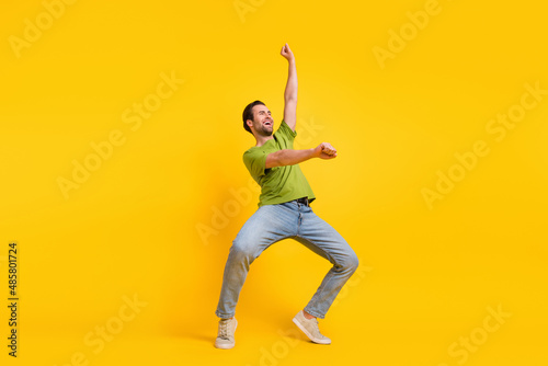 Full size profile side photo of young man have fun ride horse look empty space isolated over yellow color background