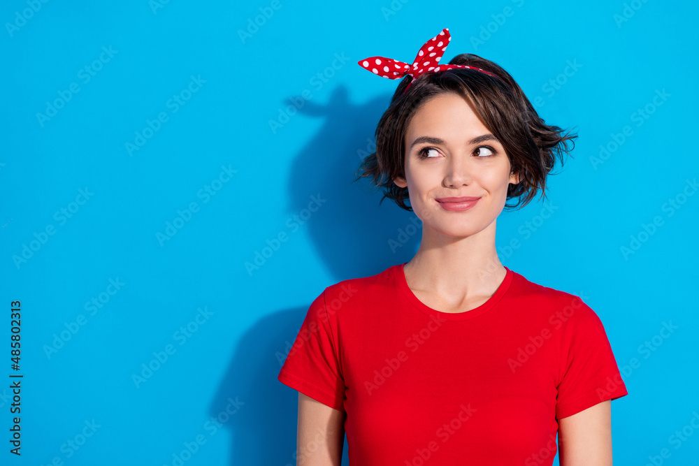 Photo of young lovely girl wonder dream think minded look empty space isolated over blue color background Photo of young lovely girl wonder dream think minded look empty space isolated over blue color background