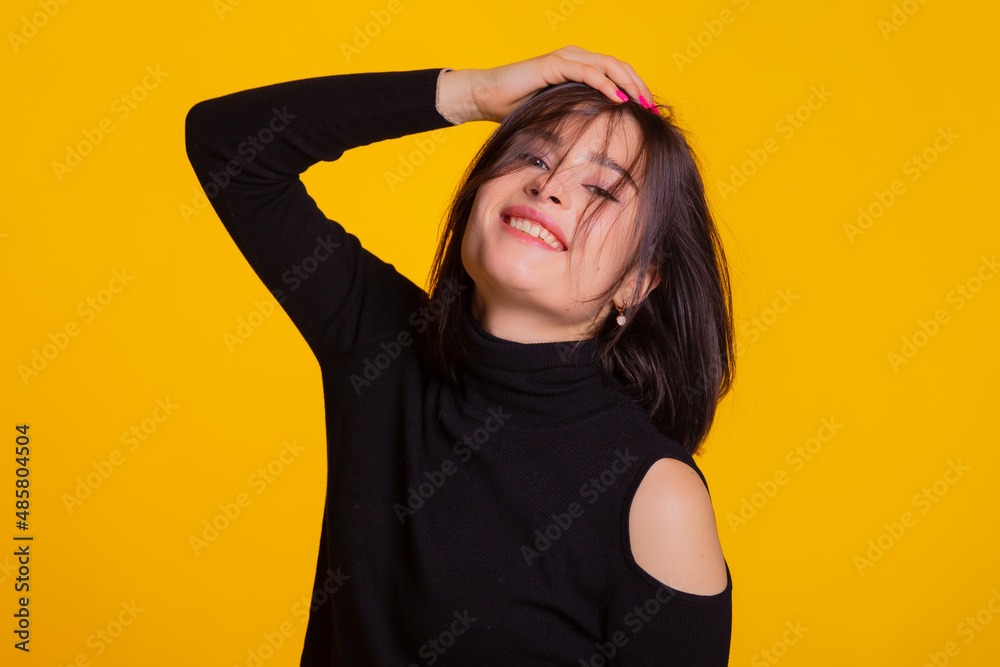 Woman with short hair being very glad smiling with broad smile having fun indoors. Joyful and excited femlae face expression isolated over yellow background with space for text. Woman with short hair being very glad smiling with broad smile having fun indoors. Joyful and excited femlae face expression isolated over yellow background with space for text.