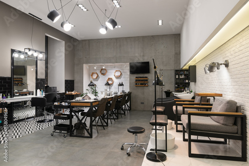 Quadro su tela Modern interior of the beauty salon which consist of nail salon and barbershop with black lamps and concrete wall