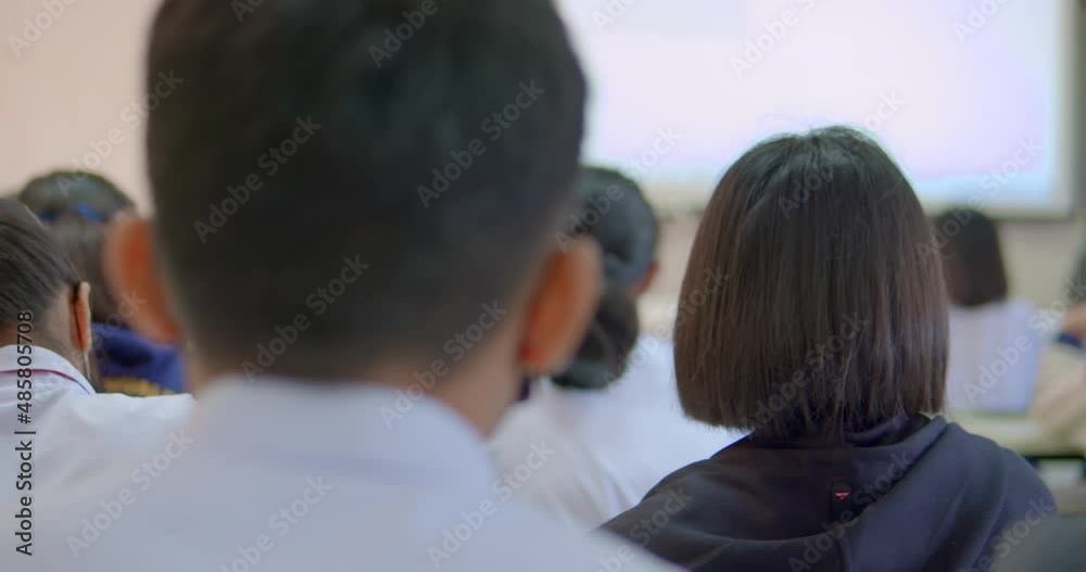 Slow motion dolly shot of Asian high school students in white uniform wearing mask for protect COVID-19, study science in classroom. Slow motion dolly shot of Asian high school students in white uniform wearing mask for protect COVID-19, study science in classroom.