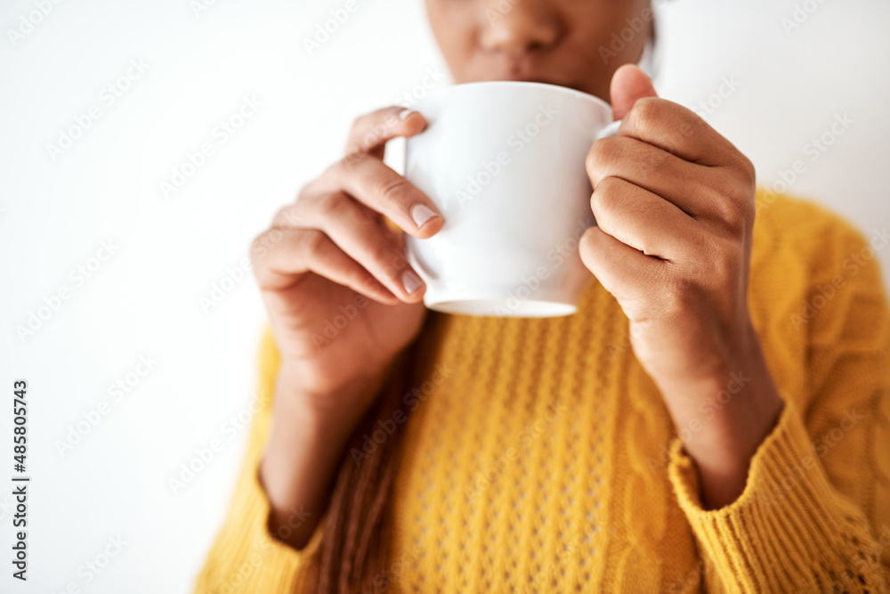 I feel so much better after this coffee. Cropped shot of an unrecognizable woman drinking a cup of coffee. I feel so much better after this coffee. Cropped shot of an unrecognizable woman drinking a cup of coffee.