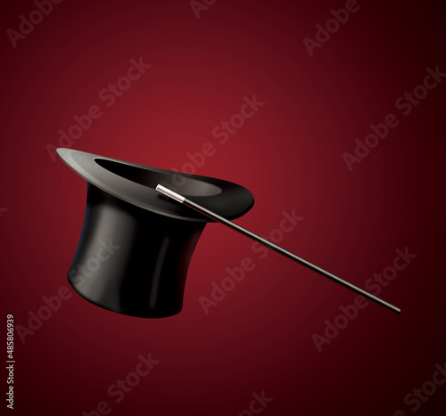 Magic black hat and magic wand isolated on red stage curtain
