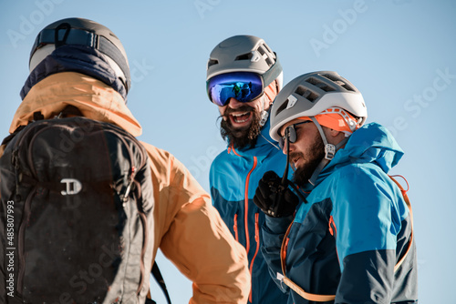 Close-up view on group of men skiers in sunglasses and a ski helmets