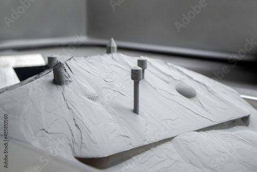 Surface with printed objects on metal 3D printer, covered metal powder inside of metal 3D printer. 3D printer printed three-dimensional object from metallic powder. Laser sintering machine for metal.
