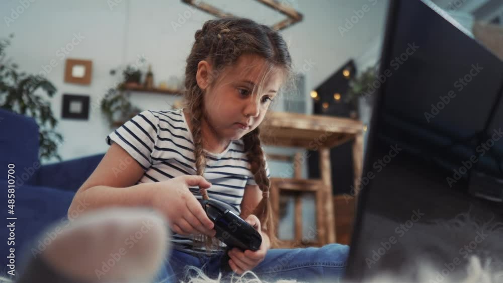 little girl playing video game on gamepad. kid dream stay home computer addiction. girl playing tablet fun online games. addiction to online games addict kid. child play video game dream