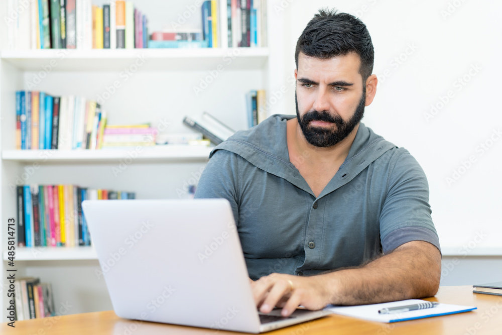 Handsome latin american software programmer with hipster beard at work Handsome latin american software programmer with hipster beard at work