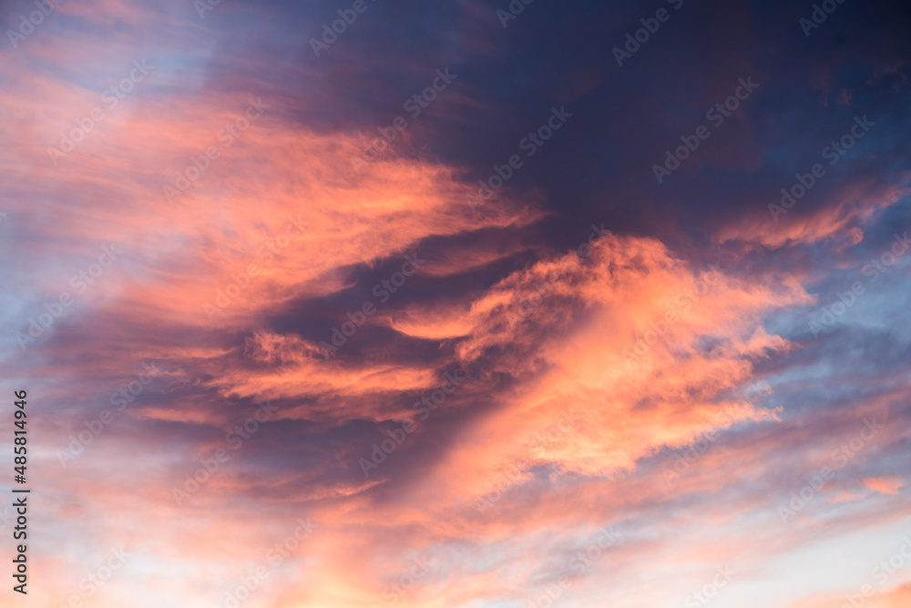 Amazing bright orange, purple and pink dramatic sunset clouds in the sky inside the Arctic Circle in Lapland, Finland