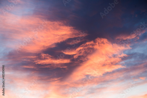 Amazing bright orange, purple and pink dramatic sunset clouds in the sky inside the Arctic Circle in Lapland, Finland