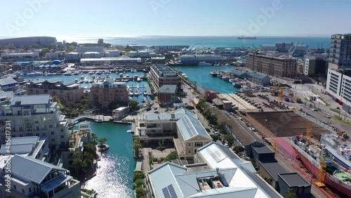Aerial shot flying over the canals towards the VA Waterfront at noon in Cape Town.
