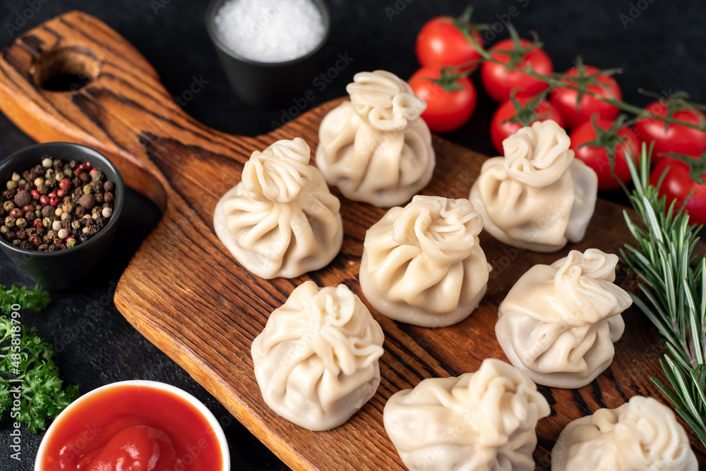 Khinkali, Georgian dumplings with meat filling on a stone background Khinkali, Georgian dumplings with meat filling on a stone background