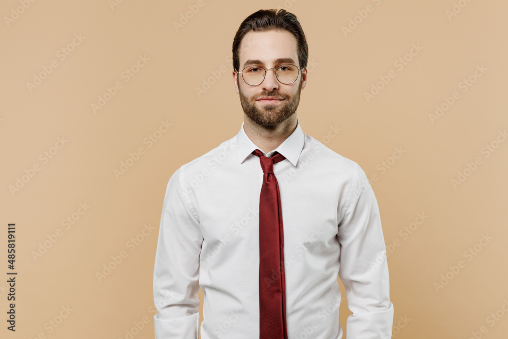 Young caucasian confident successful employee business man corporate lawyer 20s wear classic formal white shirt red tie glasses work in office isolated on plain beige color background studio portrait. Young caucasian confident successful employee business man corporate lawyer 20s wear classic formal white shirt red tie glasses work in office isolated on plain beige color background studio portrait.