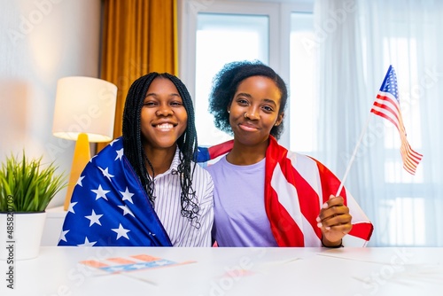 Tablou canvas two happy african american sister celebrating usa independence day at home in co