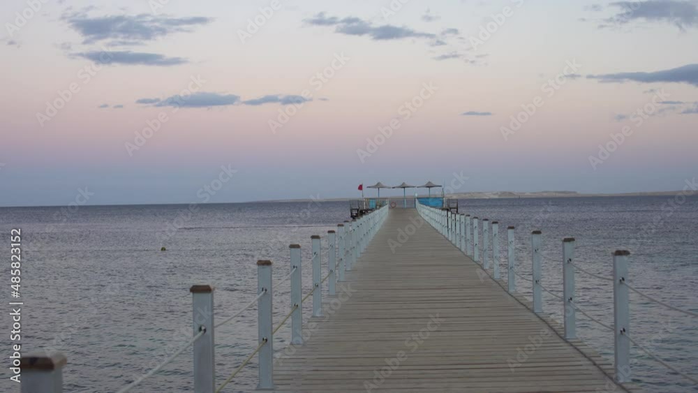 Dilapidated Pier in the Red Sea. Tiran Island on Backdrop.