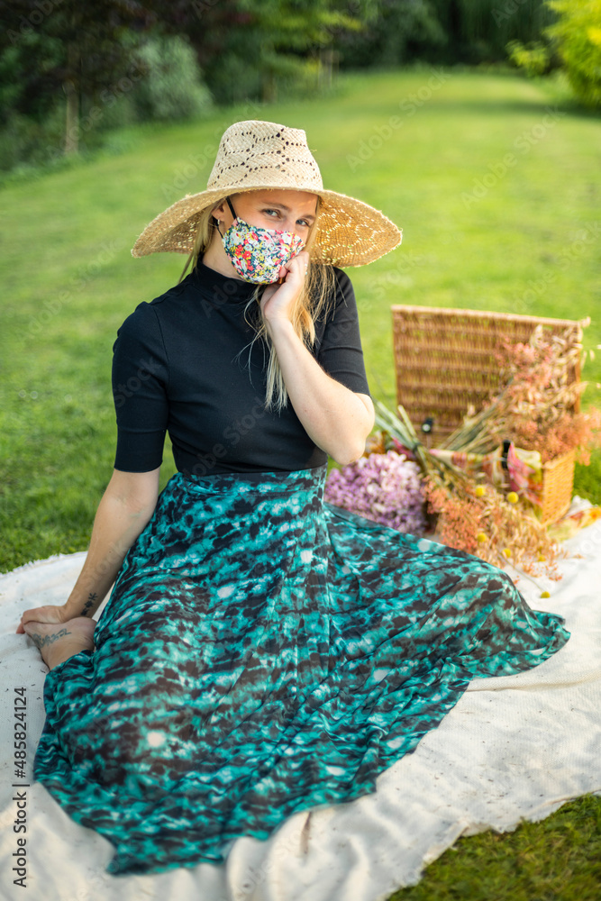 Woman wearing a coronavirus face mask covering during Covid-19 pandemic on an editorial fashion shoot