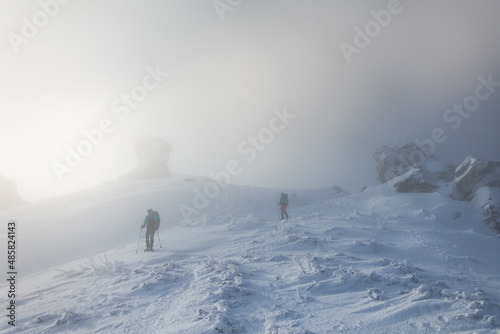 two women climbed to the top of the mountain during a fog © zhukovvvlad
