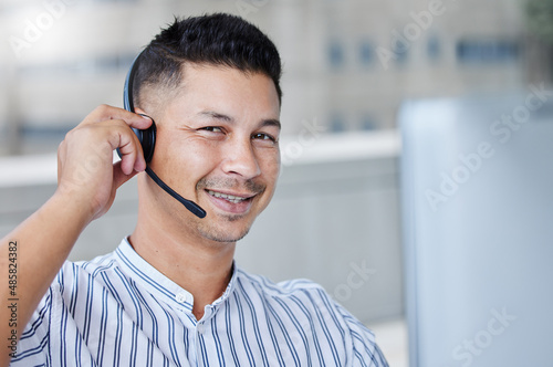 Yes we should be able to handle this no problem. Shot of a young businessman working in a call center office helping a client.