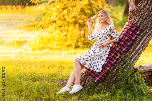 blonde woman resting in a summer park