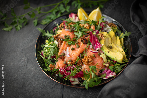 Super Sirtuin salad in a stylish black plate over black background