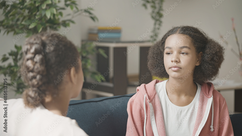 Serious African American teen girls discussing a problem, conflict between friends Serious African American teen girls discussing a problem, conflict between friends
