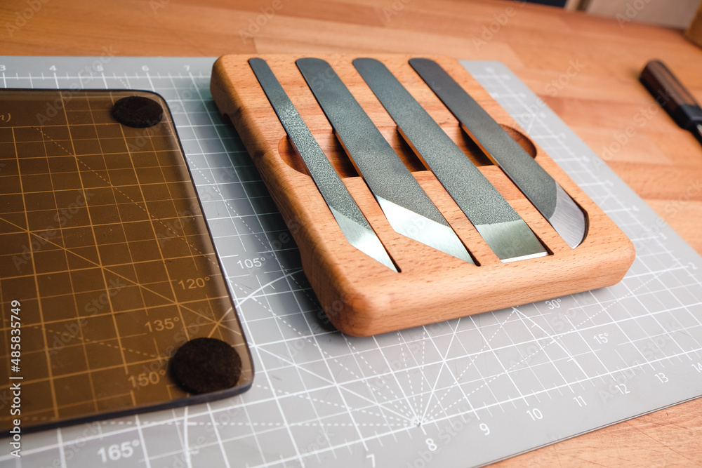 Naklejka premium Set of handmade leather craft Skiving knife blade in the wooden box . Close up tanner tool Chartermade.
