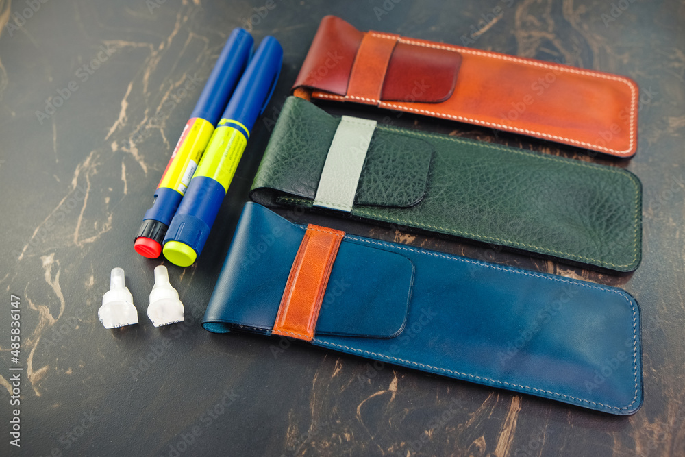 Leather insulin pen cases different colors for people with diabetes. Genuine leather craft. Flat lay.