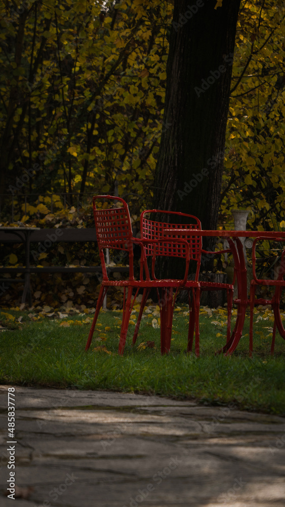 a garden, table and red chairs