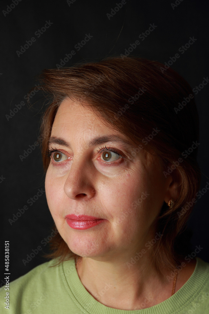 A middle-aged woman with a pensive look A middle-aged woman with a pensive look