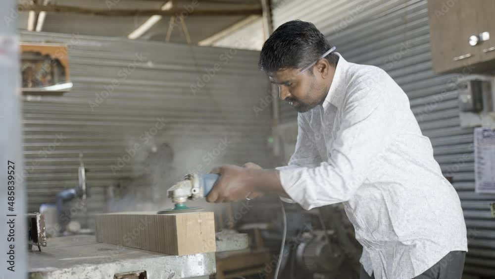 Indian carpenter polishing wood by using carpentry tools at workshop - concept of self-employment, small business and self employed. Indian carpenter polishing wood by using carpentry tools at workshop - concept of self-employment, small business and self employed.