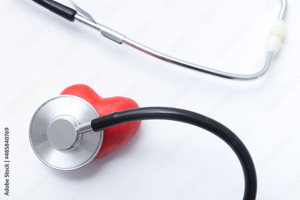 Red heart with medical stethoscope. Insurance health or heart treatment, mental health concept Red heart with medical stethoscope. Insurance health or heart treatment, mental health concept