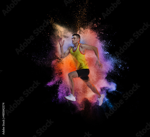 Collage. Man, professional running athlete training isolated over black background with colorful powder explosion