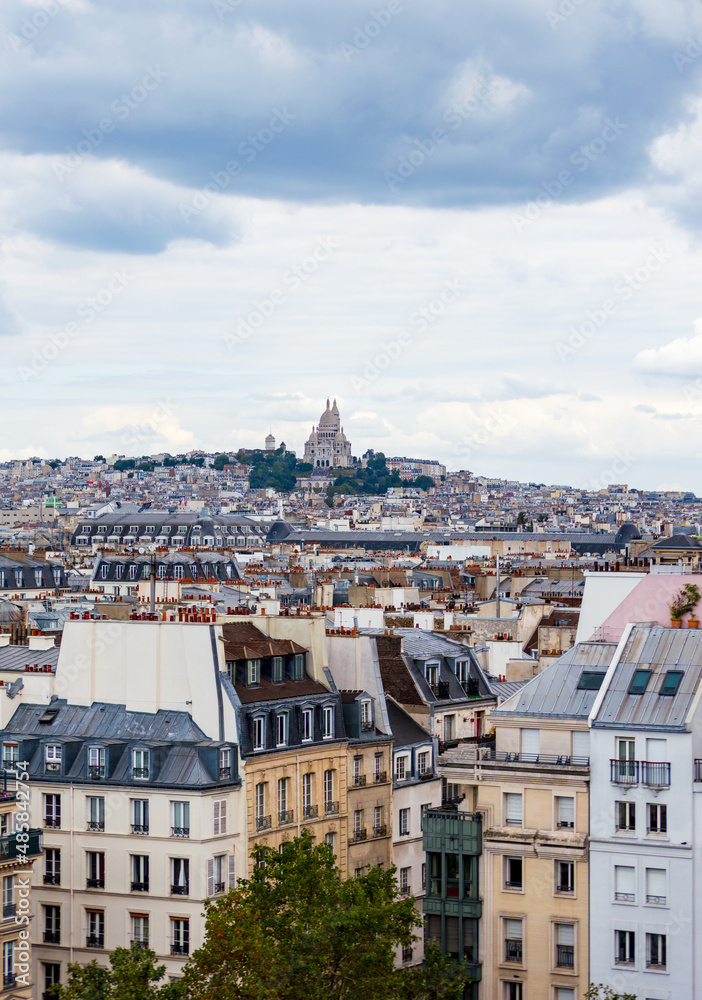 Naklejka premium Paris cityscape from above. Montmartre hill and Sacre Coer church stand out in the view