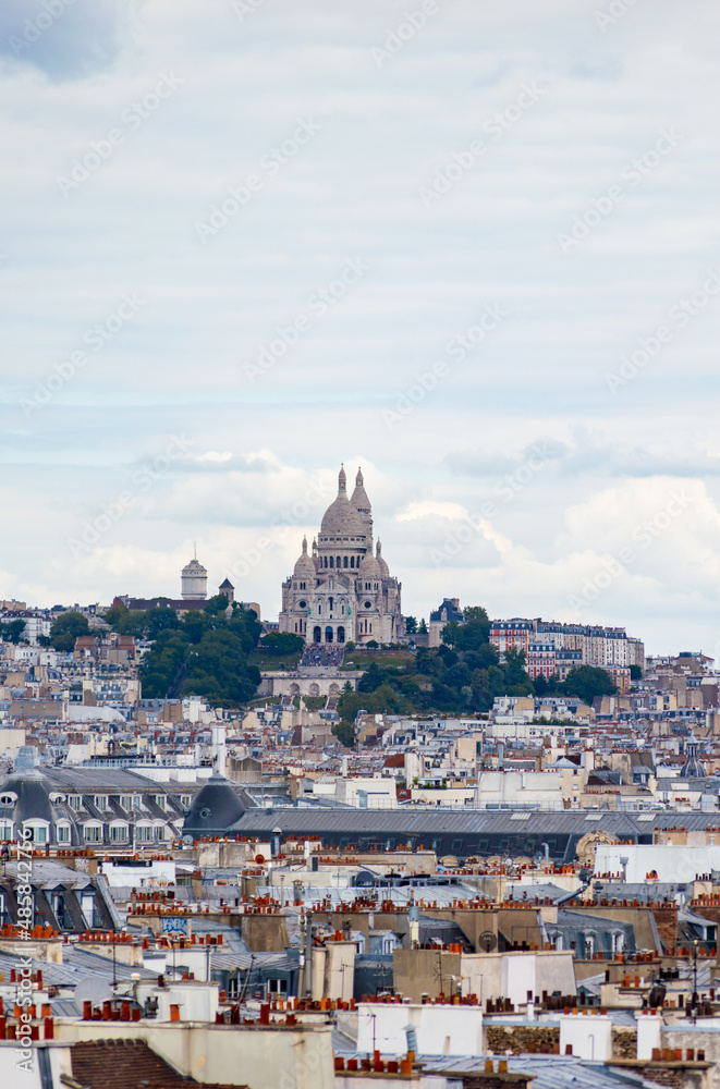 Paris cityscape from above. Montmartre hill and Sacre Coer church stand out in the view