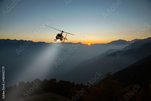 Canvastavla helicopter with lighthouse in night flight in the high mountains