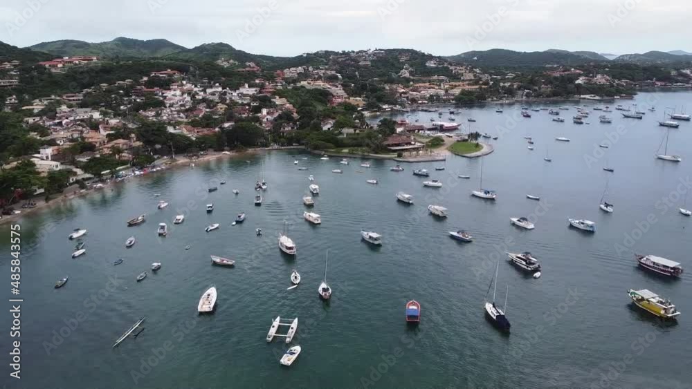 Top view of Ossos beach with beautiful green water and boats on the shore, Armação de Búzios, Rio de Janeiro - drone view