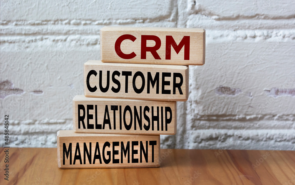 Fototapeta premium CRM Customer Relationship Management System, text on wooden blocks