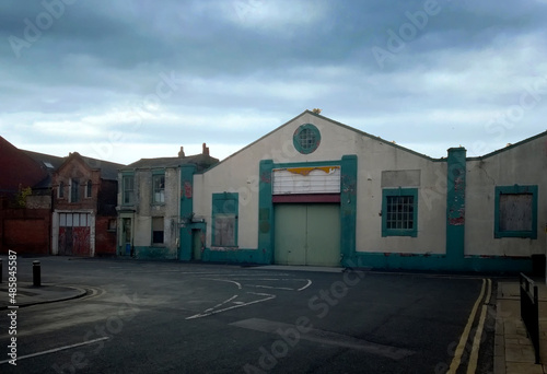 an empty street full of derelict abandoned building under a dark cloudy sky