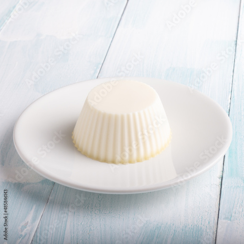 White panna cotta in a dish on white background