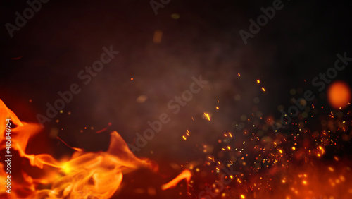 Fotografia Fire embers particles over black background
