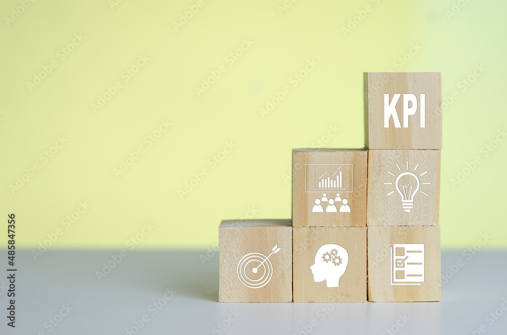 Wooden cubes with KPI Key Performance Indicator symbol on background and copy space.Business concepts. Wooden cubes with KPI Key Performance Indicator symbol on background and copy space.Business concepts.