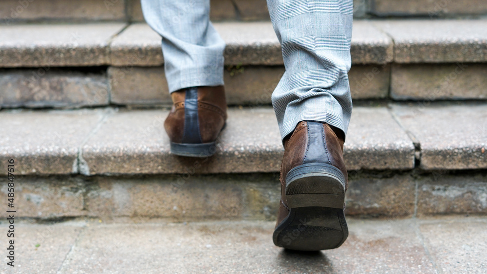 Business man walking up stairs, low section Business man walking up stairs, low section