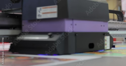Modern Digital Large format UV printer. Printing production technologies. UV pinning is the process of applying a dose of low intensity ultraviolet light to a UV curable ink photo