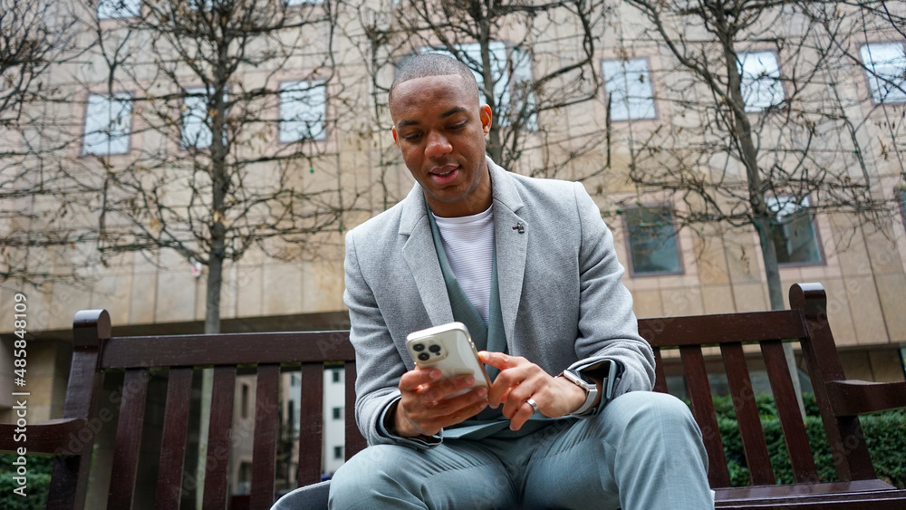 Fototapeta premium Business man using phone outside office building