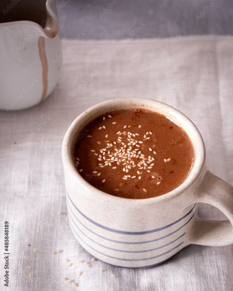 Fototapeta premium Close up of hot chocolate in a striped mug.