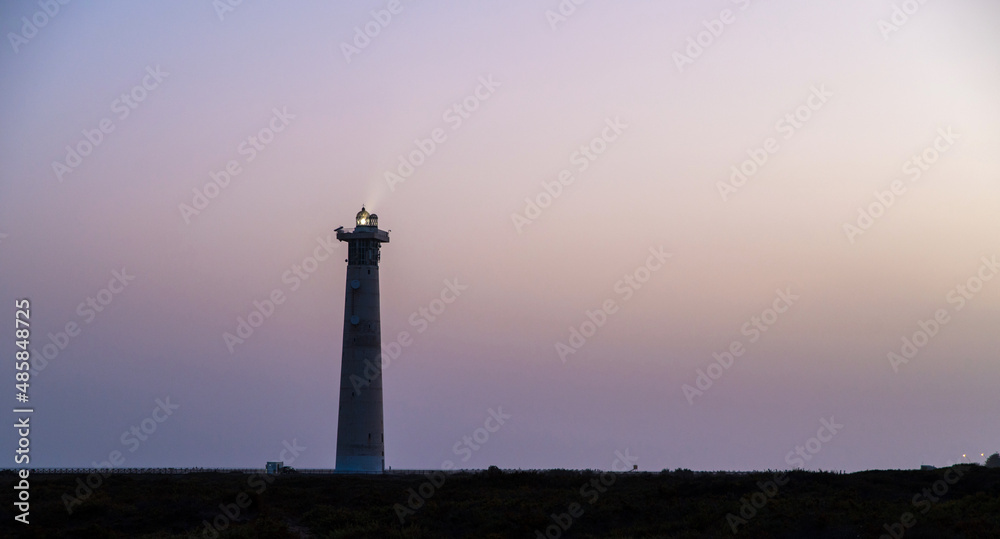 Lighthouse on seashore in evening Lighthouse on seashore in evening