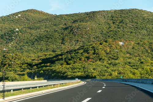 hills in croatia near the highway, beautiful summer mountain landscape, blue sky and clouds